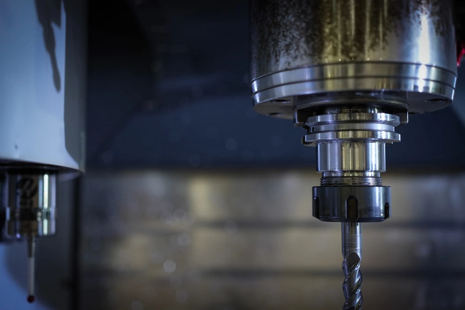 Close-up of CNC mill spindle and tool holder with carbide drill bit