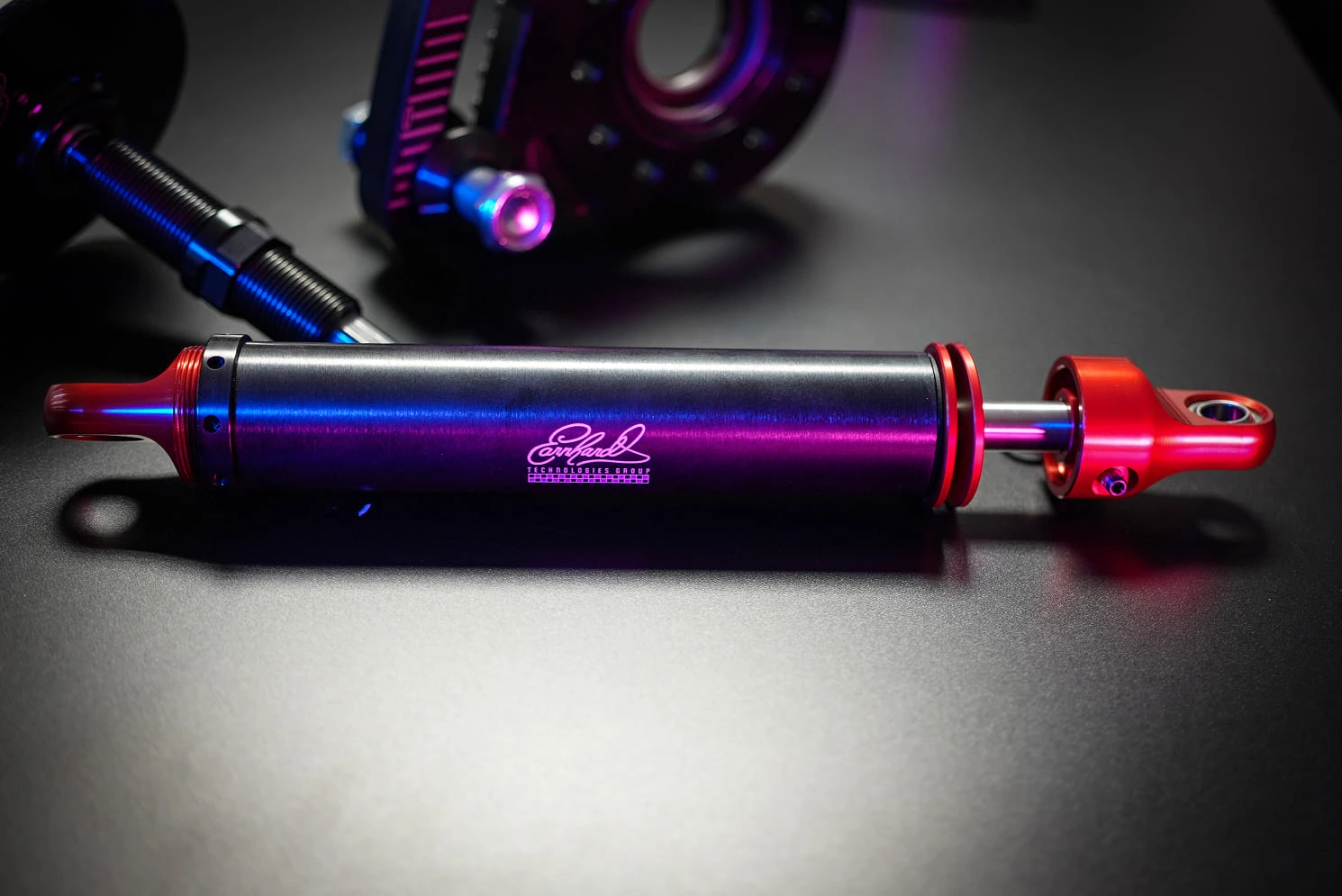 Close-up of precision-machined black anodized racing component with engraved ETG logo