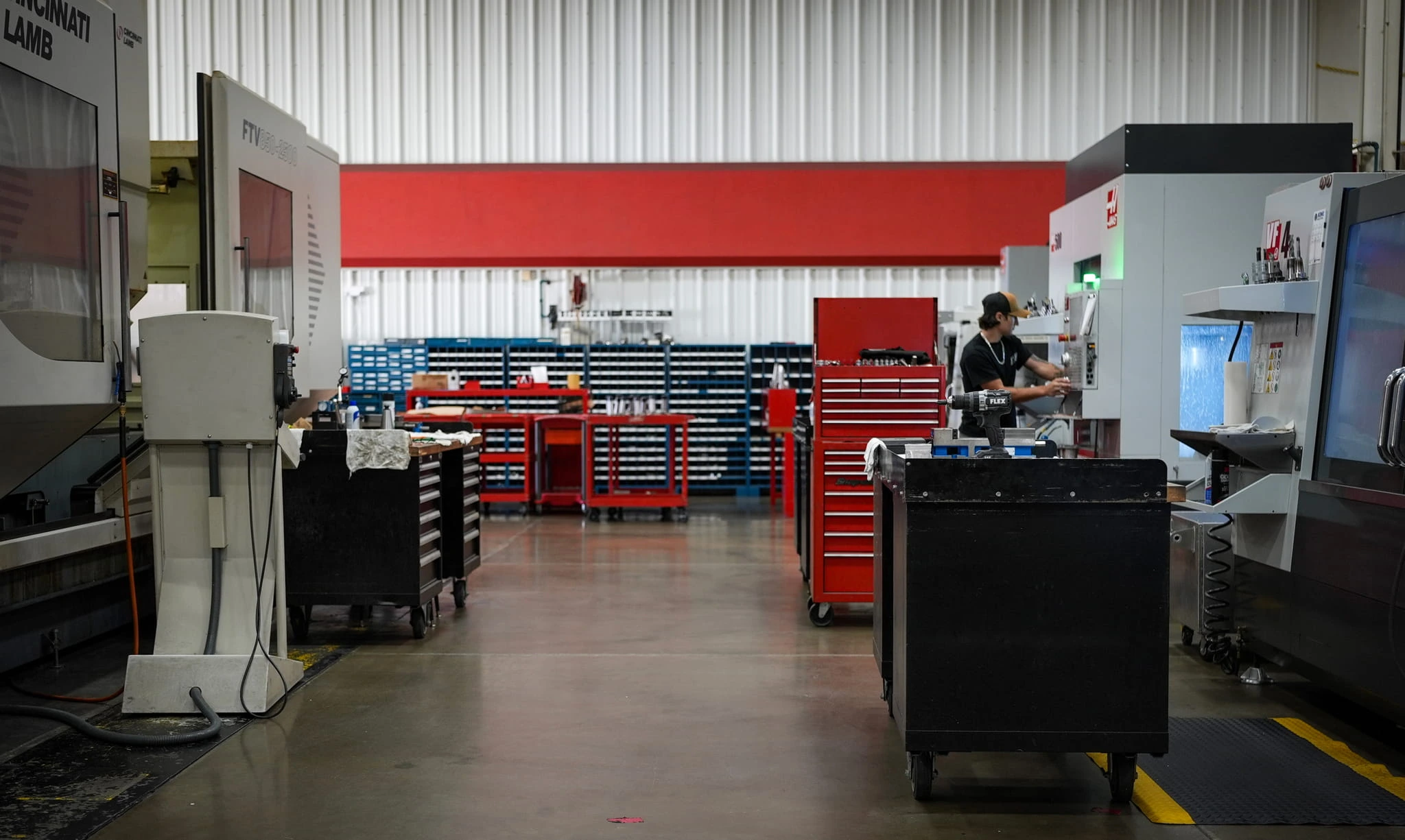 ETG machinist operating Haas CNC machine with Cincinnati Lamb and tool storage in the Mooresville facility