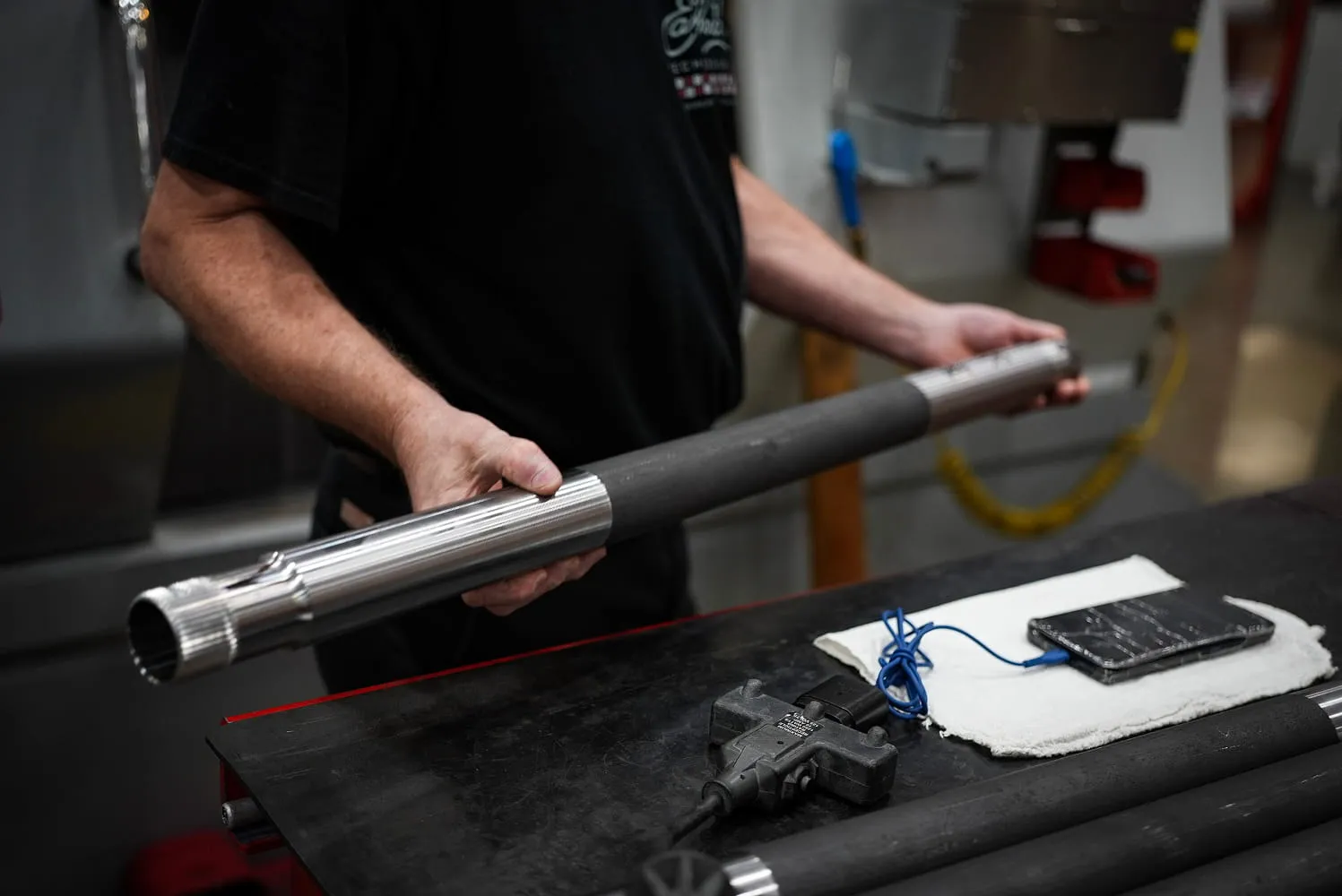 ETG technician inspecting precision-machined splined steel shaft after turning