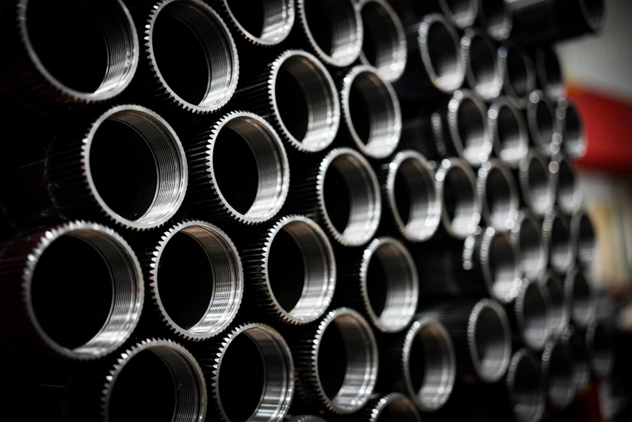 Rows of precision machined cylindrical metal parts for defense applications