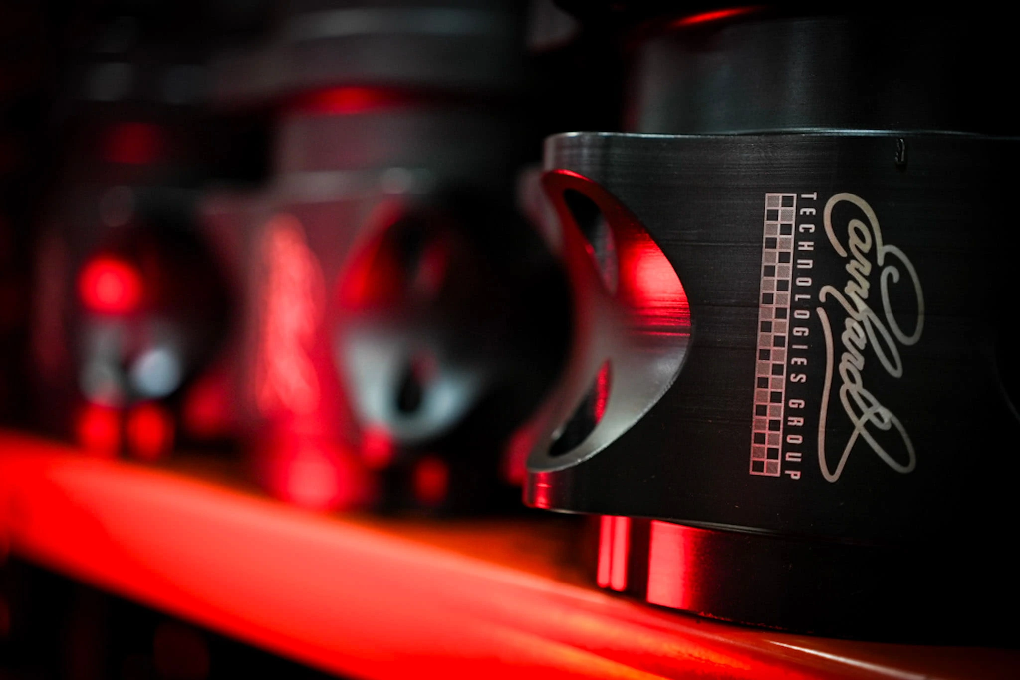 Black anodized steering stem clamp with laser-engraved Earnhardt Technologies Group logo and checkered flag detail