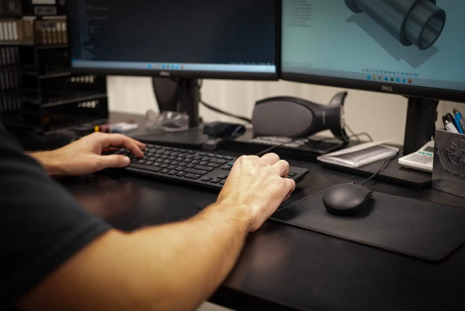 ETG engineer designing racing component in CAD software on dual monitor workstation