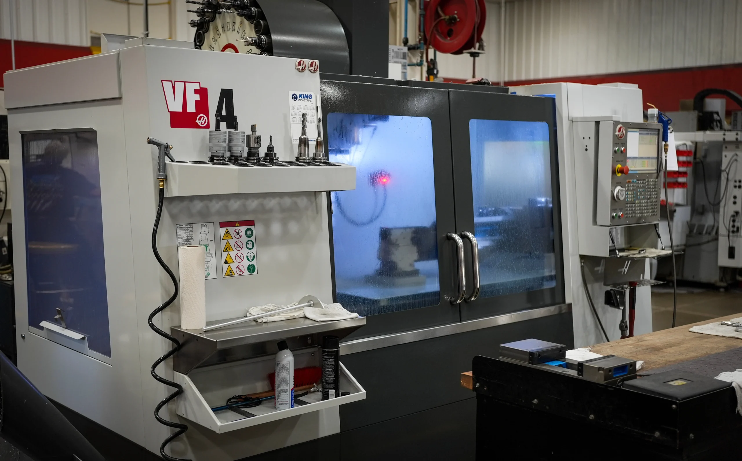 Haas VF-4 vertical machining center with 4th-axis rotary table running production at ETG