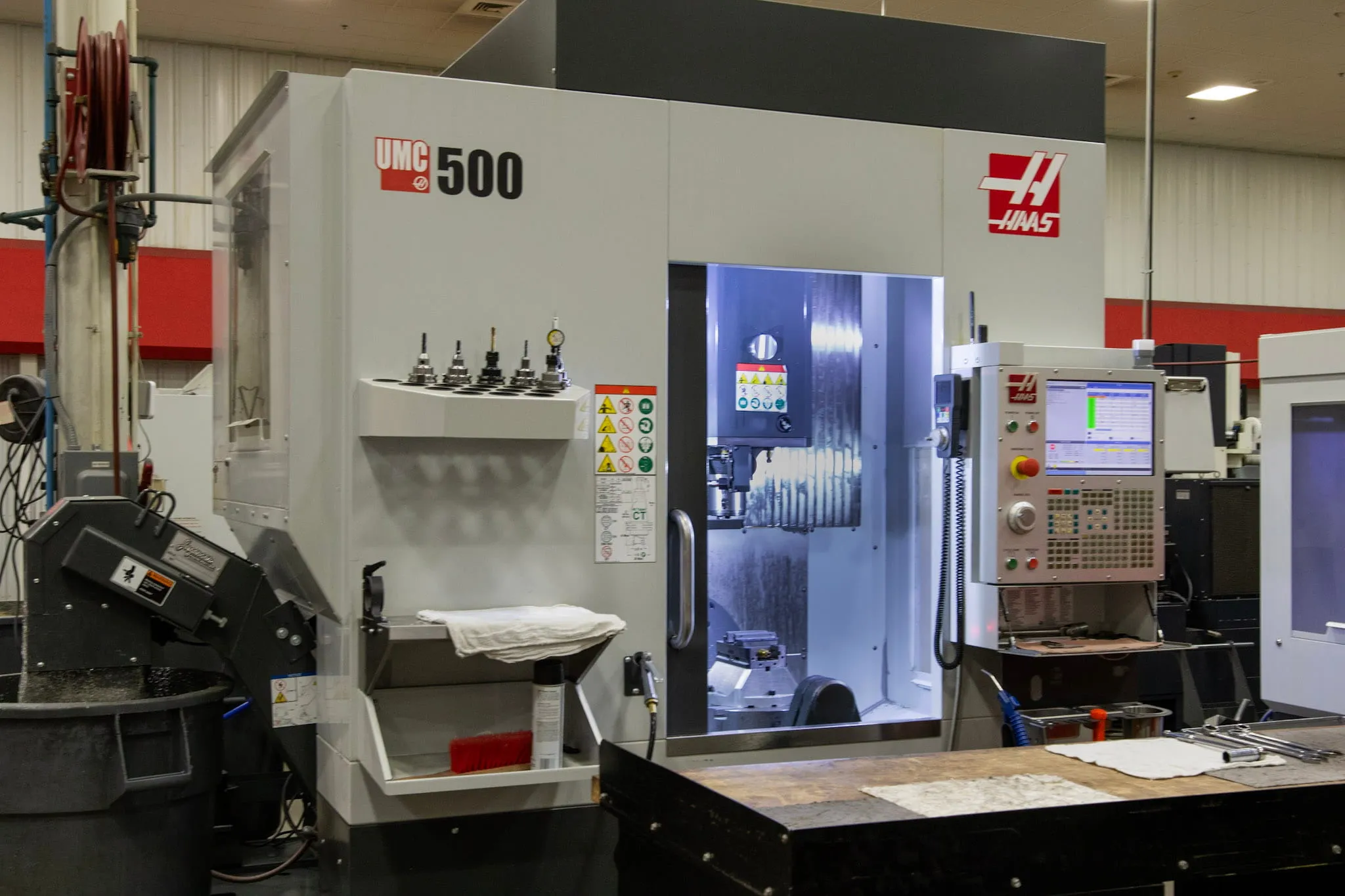 Haas UMC-500 5-axis vertical machining center running precision operation at ETG