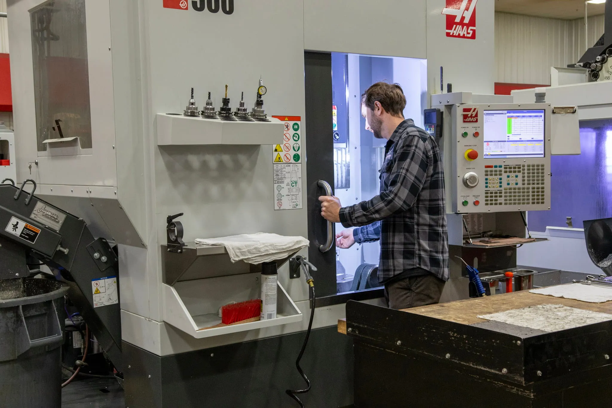 ETG machinist operating Haas UMC-500 5-axis machining center with 15k rpm spindle